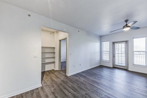 Spacious living room with cozy seating and modern decor at Aventura Falcon Valley Apartments