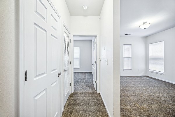 Hallway with modern lighting and elegant dÃ©cor at Aventura Falcon Valley Apartments