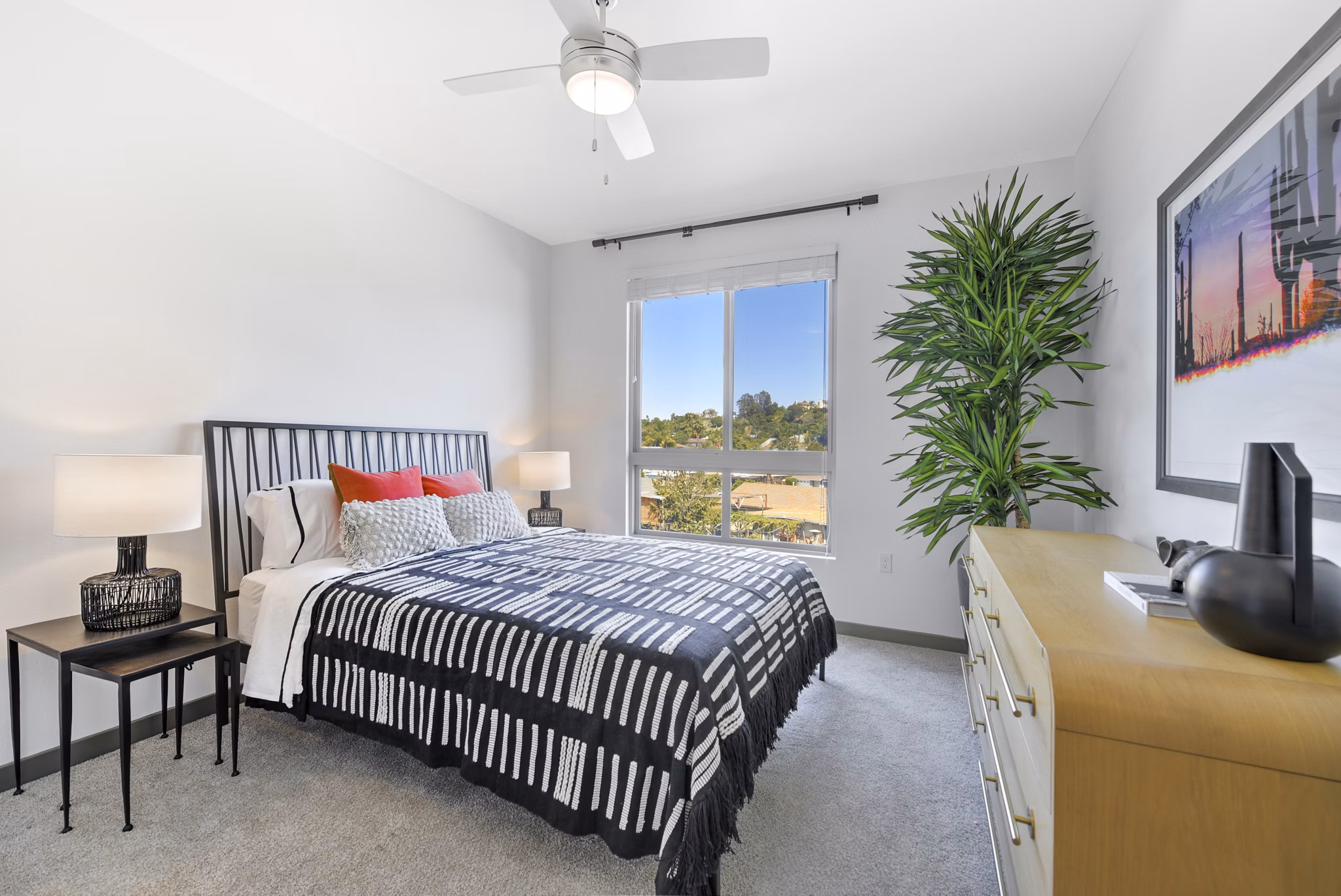 Modern bedroom featuring cozy linens and stylish decor at Persea Apartments