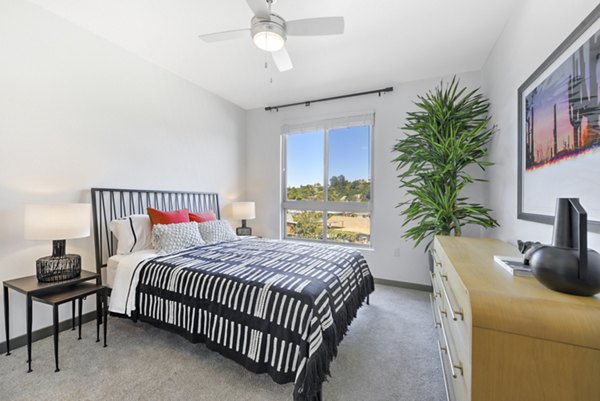 Modern bedroom featuring cozy linens and stylish decor at Persea Apartments