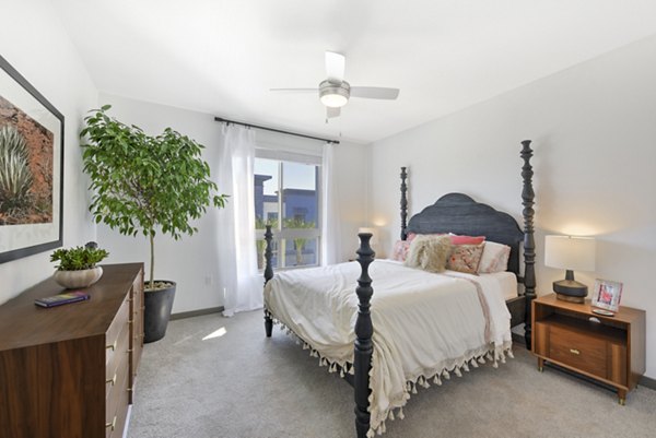 Modern bedroom with stylish decor at Persea Apartments, featuring plush bedding and elegant lighting for a luxury living experience