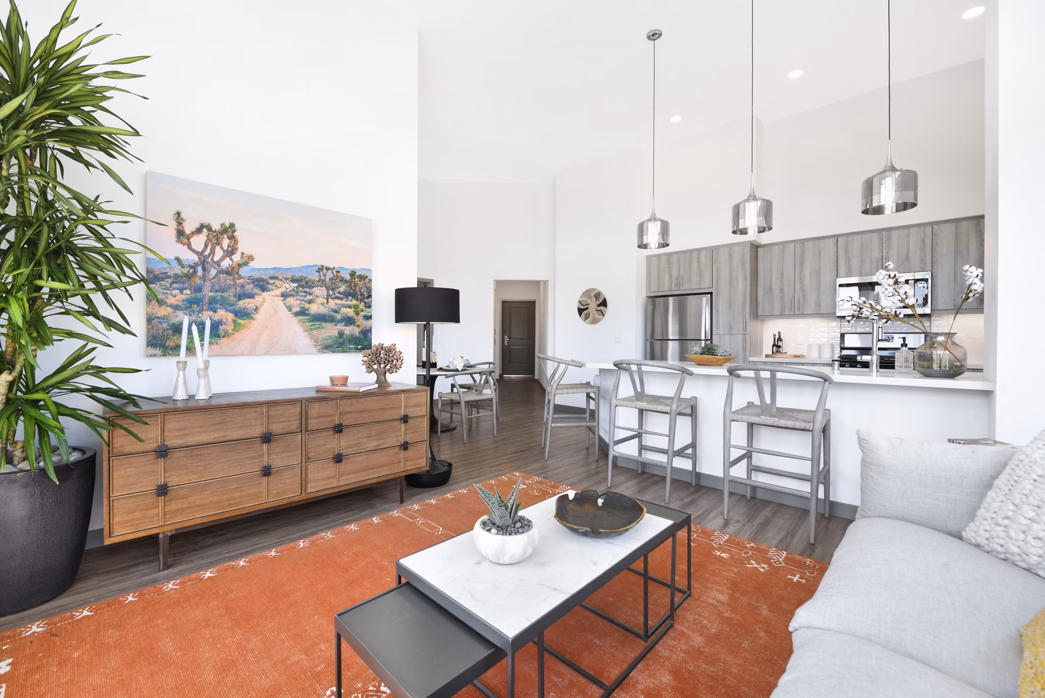 Spacious living room with modern decor and natural light at Persea Apartments, providing luxury living spaces for residents