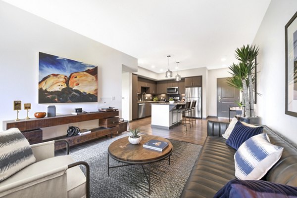 Spacious living room with modern decor in Persea Apartments, luxury living by Greystar