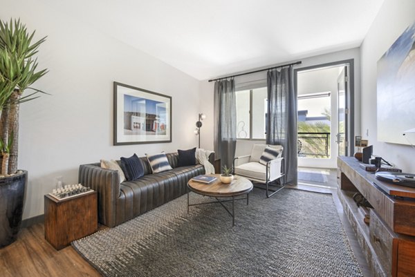 Modern living room with contemporary decor at Persea Apartments, luxury property managed by Greystar