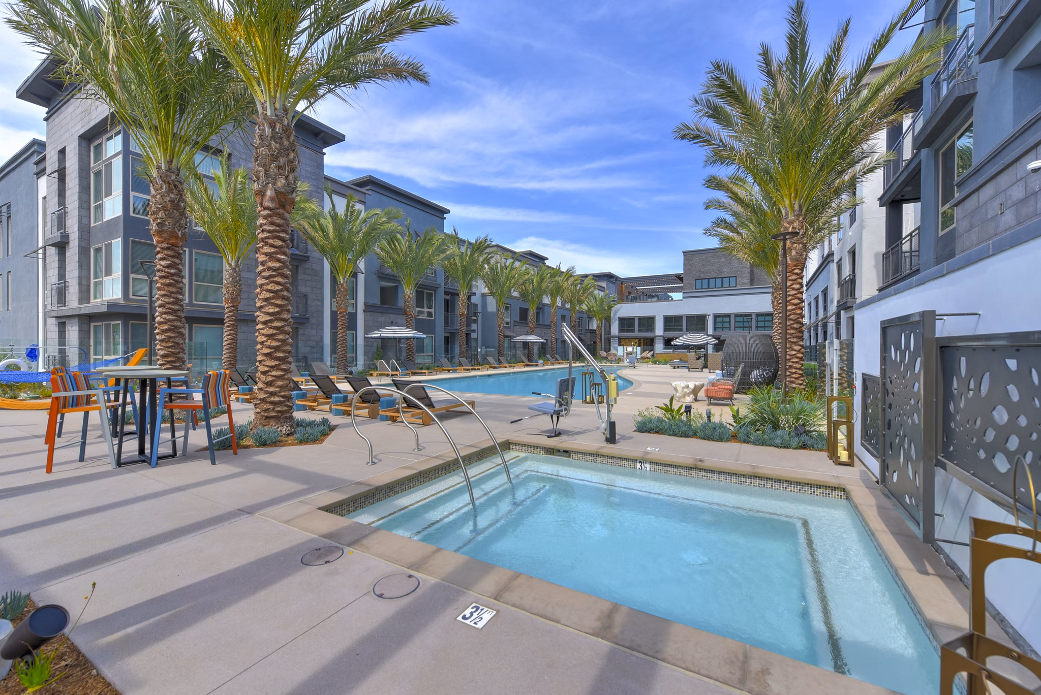 Serene outdoor pool with lounge chairs at Persea Apartments, a luxury Greystar community offering modern amenities
