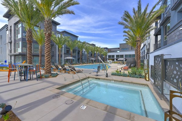 Serene outdoor pool with lounge chairs at Persea Apartments, a luxury Greystar community offering modern amenities