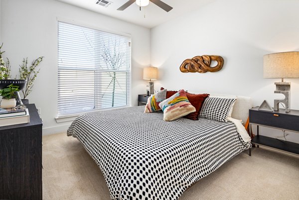 Cozy bedroom with modern furnishings in Rye Charlotte Ave Apartments, offering a luxurious living experience