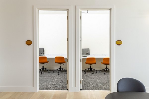 Clubhouse business center with modern workstations at Rye Charlotte Ave Apartments, offering luxury workspaces for residents
