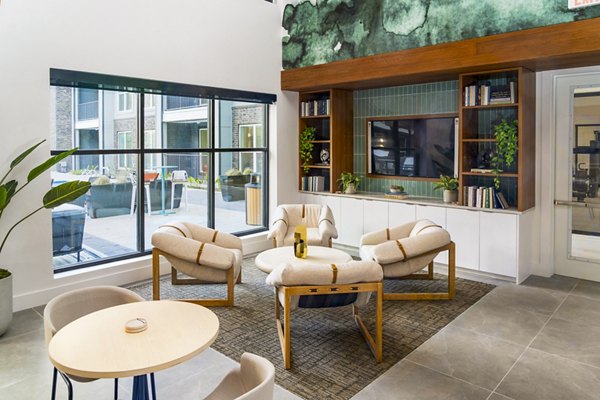 Clubhouse featuring stylish decor and modern seating at Rye Charlotte Ave Apartments, offering luxury community space for residents
