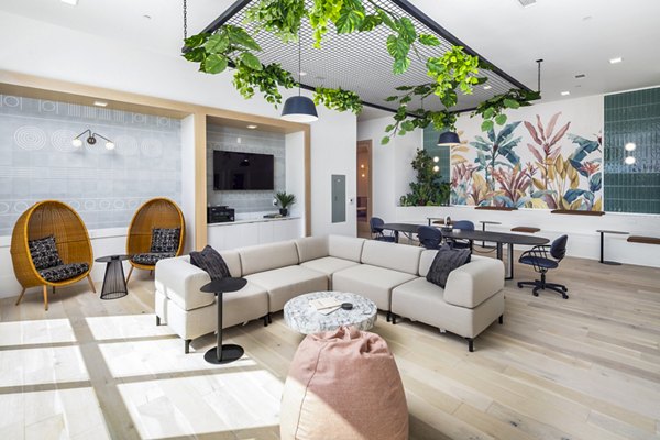 Modern clubhouse with seating areas and pool table at Rye Charlotte Ave Apartments