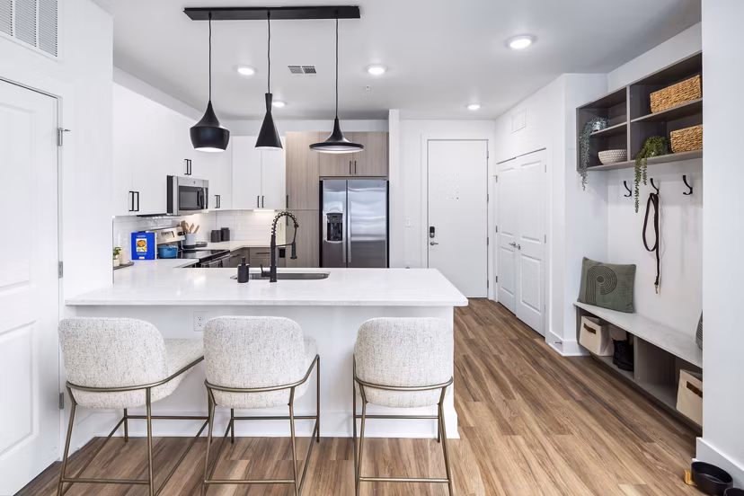 Modern kitchen with stainless steel appliances at Rye Charlotte Ave Apartments