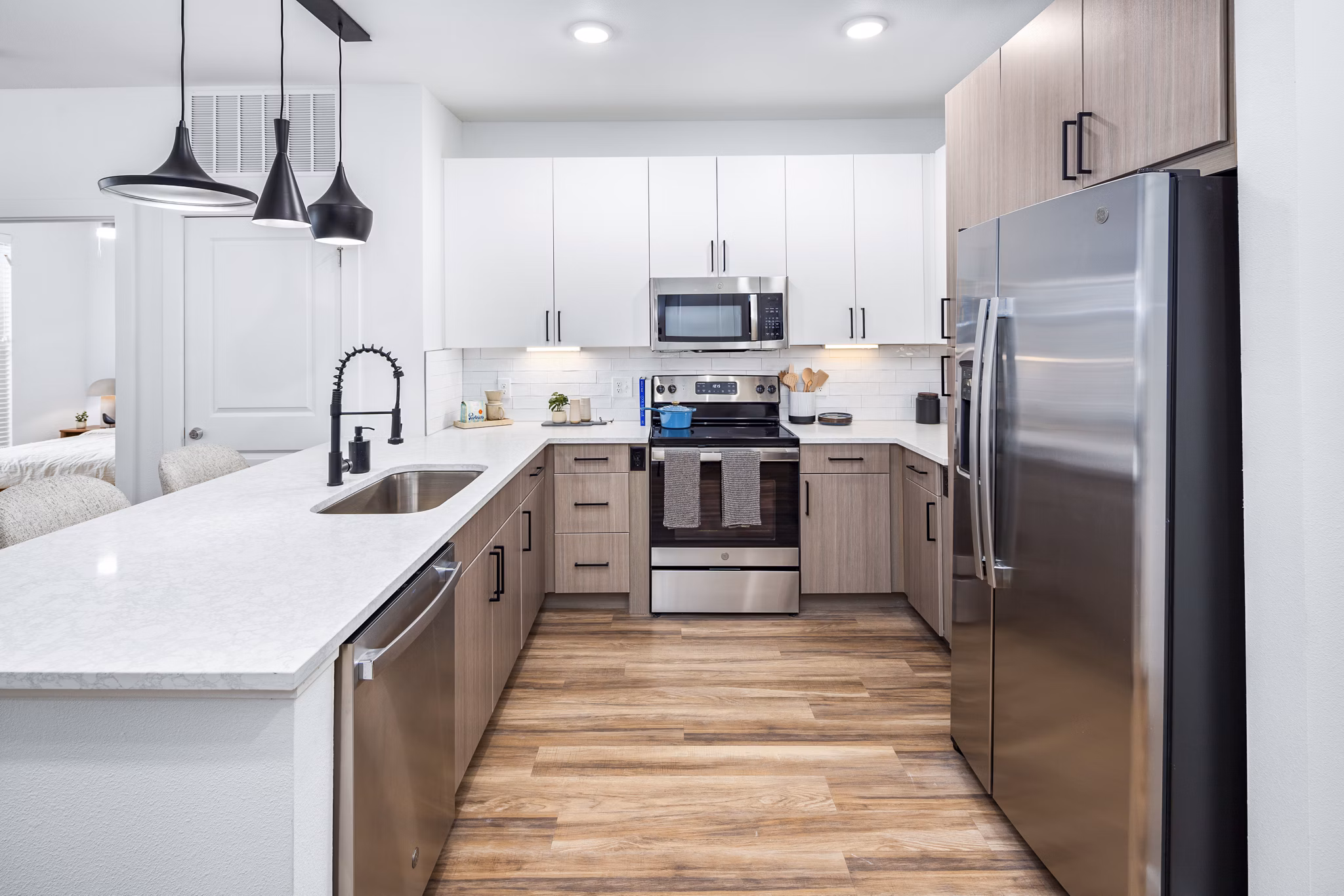 Modern kitchen with stainless steel appliances at Rye Charlotte Ave Apartments