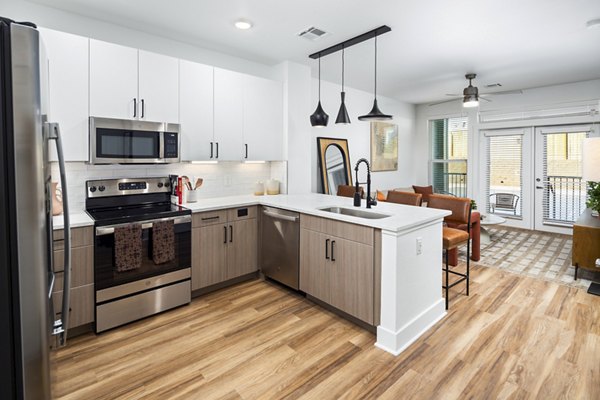 Kitchens combining modern appliances and granite countertops in Rye Charlotte Ave Apartments
