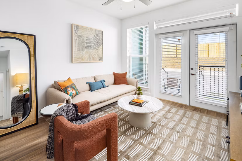 Spacious living room with modern furniture in Rye Charlotte Ave Apartments