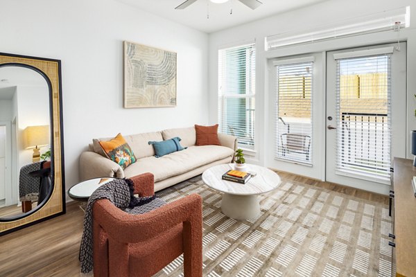Spacious living room with modern furniture in Rye Charlotte Ave Apartments