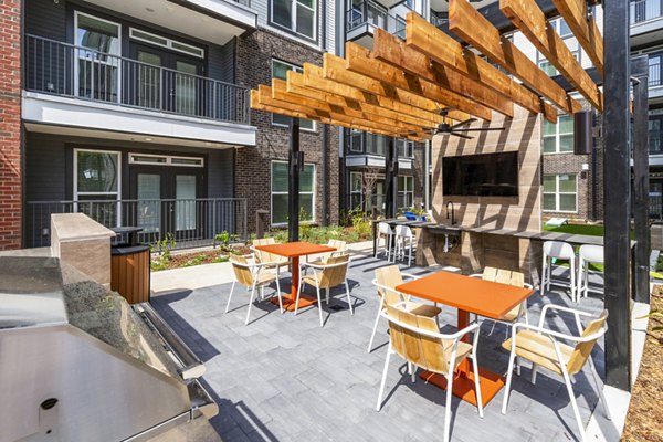 Outdoor grill area on modern patio at Rye Charlotte Ave Apartments, perfect for gatherings and alfresco dining in a luxury setting