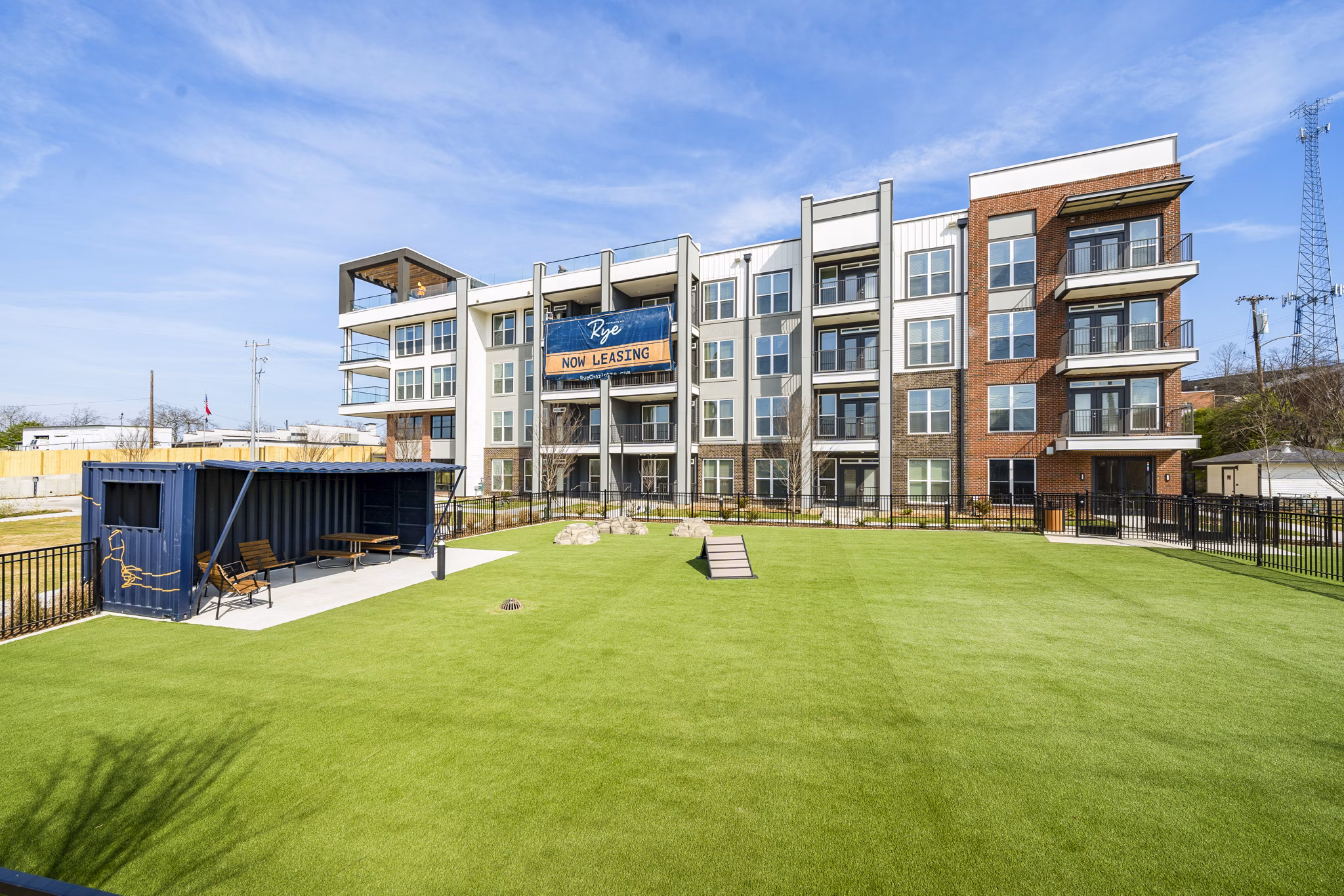 Dog park for Rye Charlotte Ave Apartments featuring lush green spaces for pet exercise and play