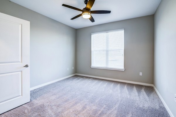 Cozy bedroom with modern decor at The Pointe at Siena Ridge Apartments
