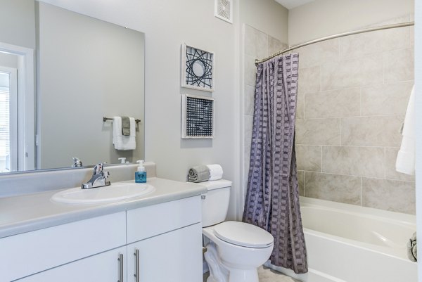 Modern bathroom with sleek fixtures at The Pointe at Siena Ridge Apartments, showcasing luxury living in a premium community