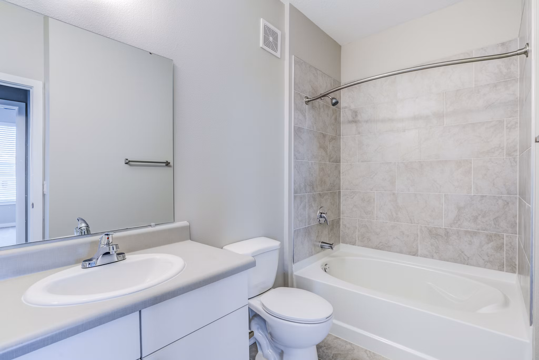 Modern bathroom with marble countertops at The Pointe at Siena Ridge Apartments