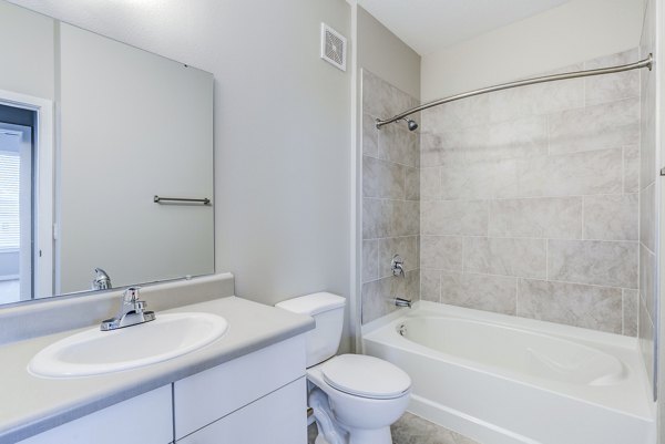 Modern bathroom with marble countertops at The Pointe at Siena Ridge Apartments