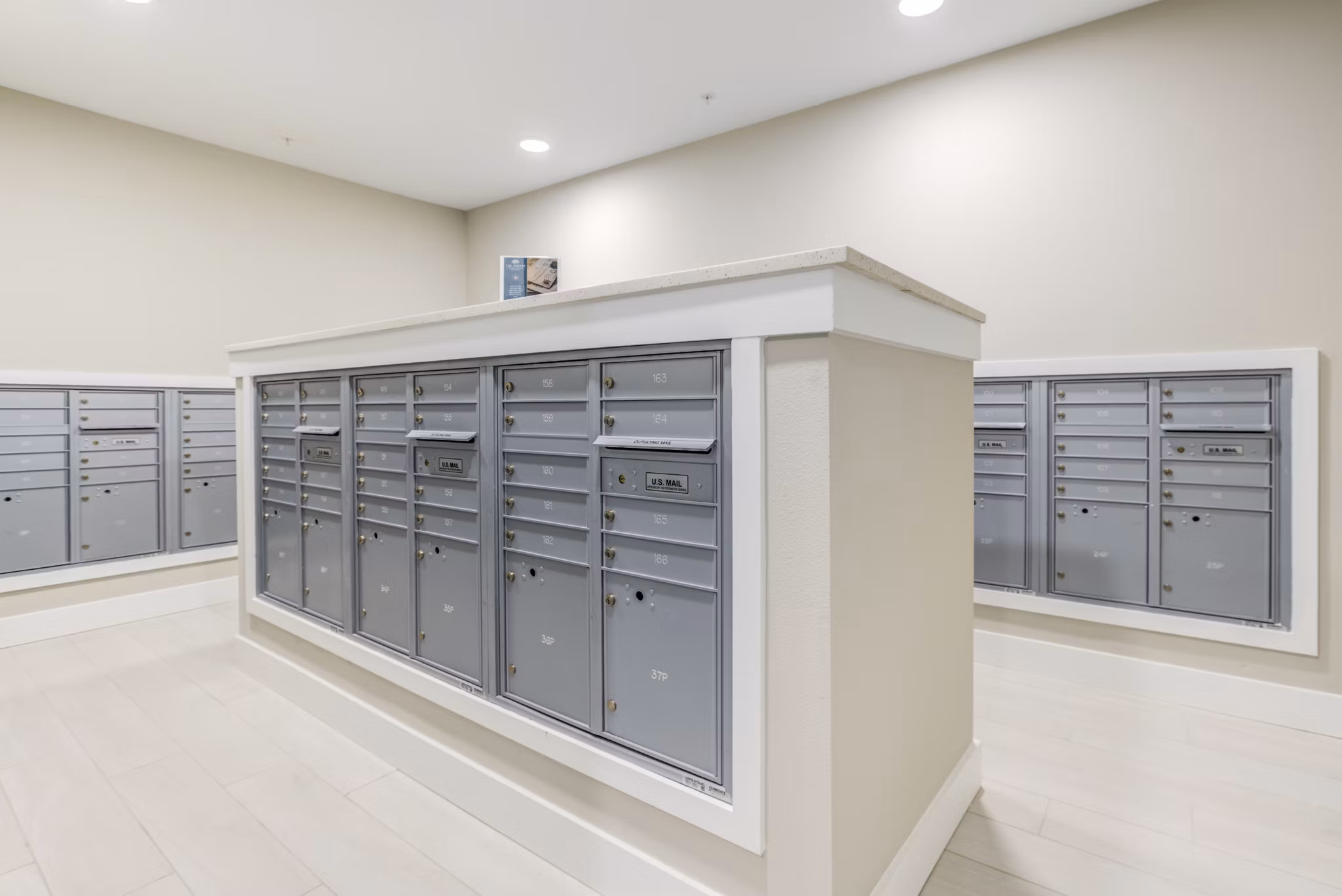 Modern mail room with parcel lockers in The Pointe at Siena Ridge Apartments clubhouse