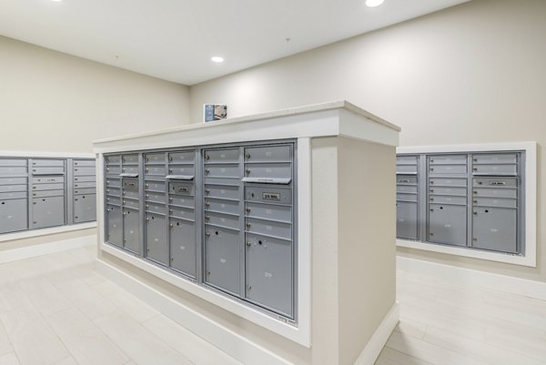 Modern mail room with parcel lockers in The Pointe at Siena Ridge Apartments clubhouse