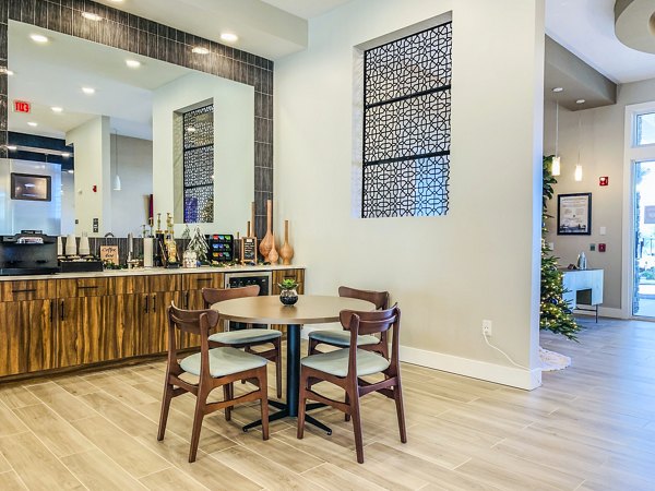Clubhouse lobby with modern decor at The Pointe at Siena Ridge Apartments, offering luxury living spaces in a welcoming community setting