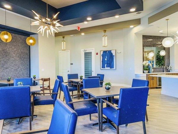 The Pointe at Siena Ridge Apartments: Elegant clubhouse lobby with cozy seating and modern decor, perfect for socializing or relaxing