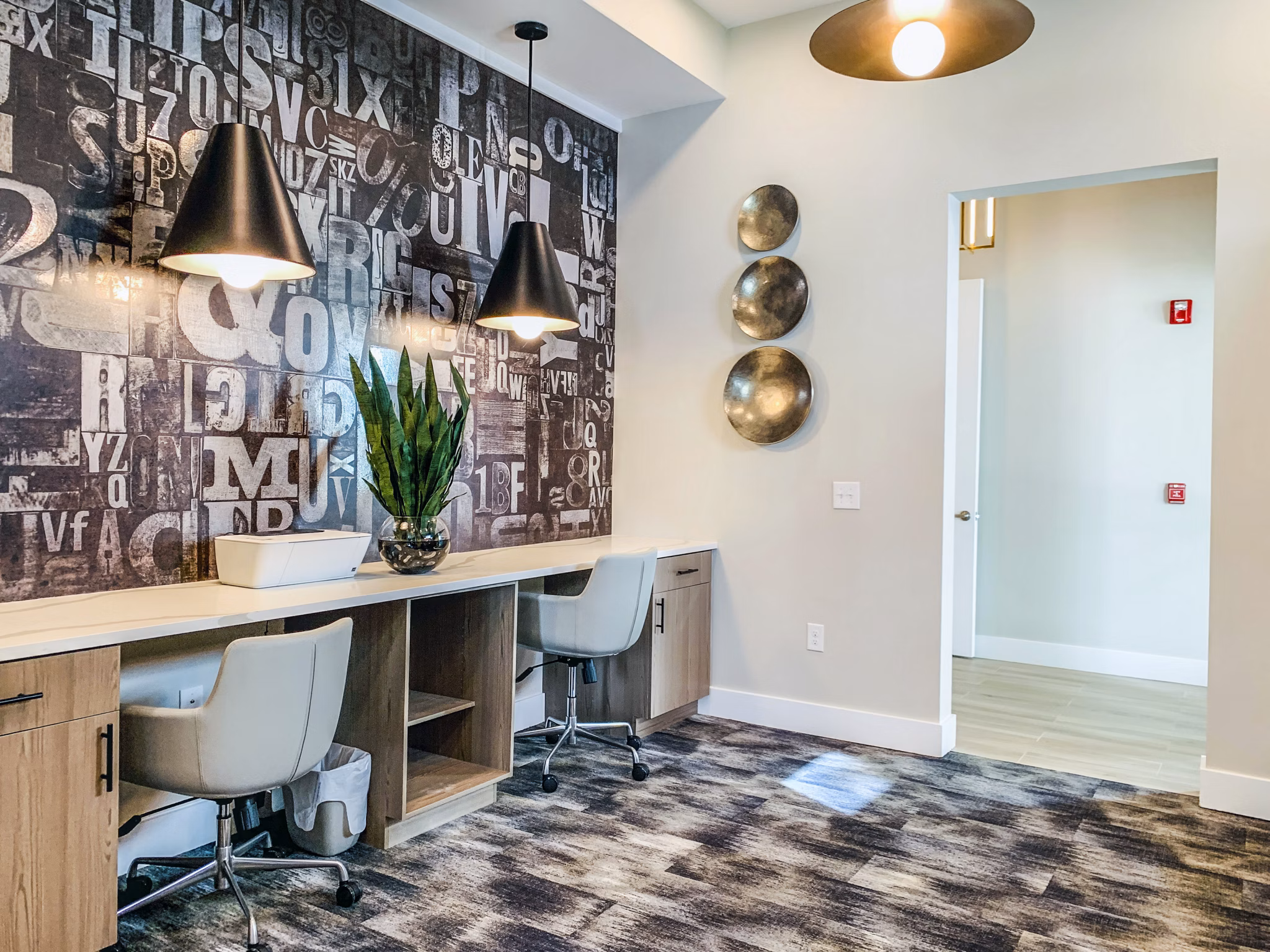 Modern clubhouse business center at The Pointe at Siena Ridge Apartments with flexible workspaces and sleek design