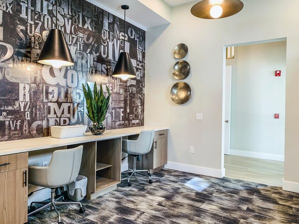 Modern clubhouse business center at The Pointe at Siena Ridge Apartments with flexible workspaces and sleek design
