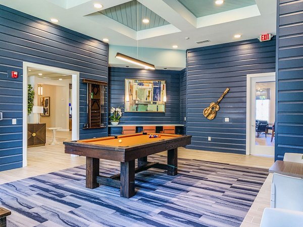 Clubhouse game room with pool table at The Pointe at Siena Ridge Apartments, luxury community living