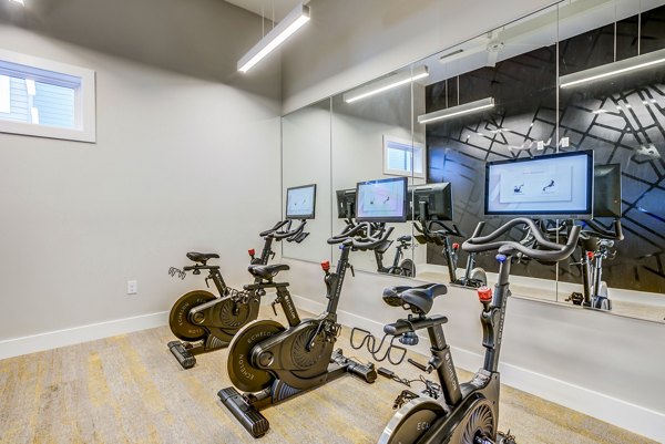 Yoga and spin studio with modern equipment at The Pointe at Siena Ridge Apartments