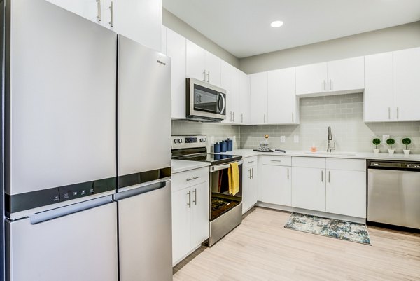 Modern kitchen with stainless steel appliances at The Pointe at Siena Ridge Apartments