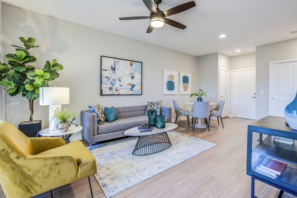 Cozy living room with modern furnishings at The Pointe at Siena Ridge Apartments