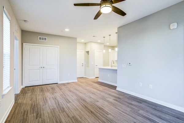 Spacious living room with modern decor at The Pointe at Siena Ridge Apartments
