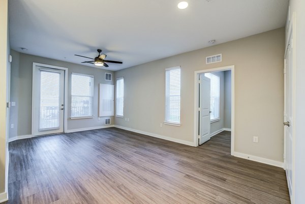 Spacious living room with modern decor at The Pointe at Siena Ridge Apartments