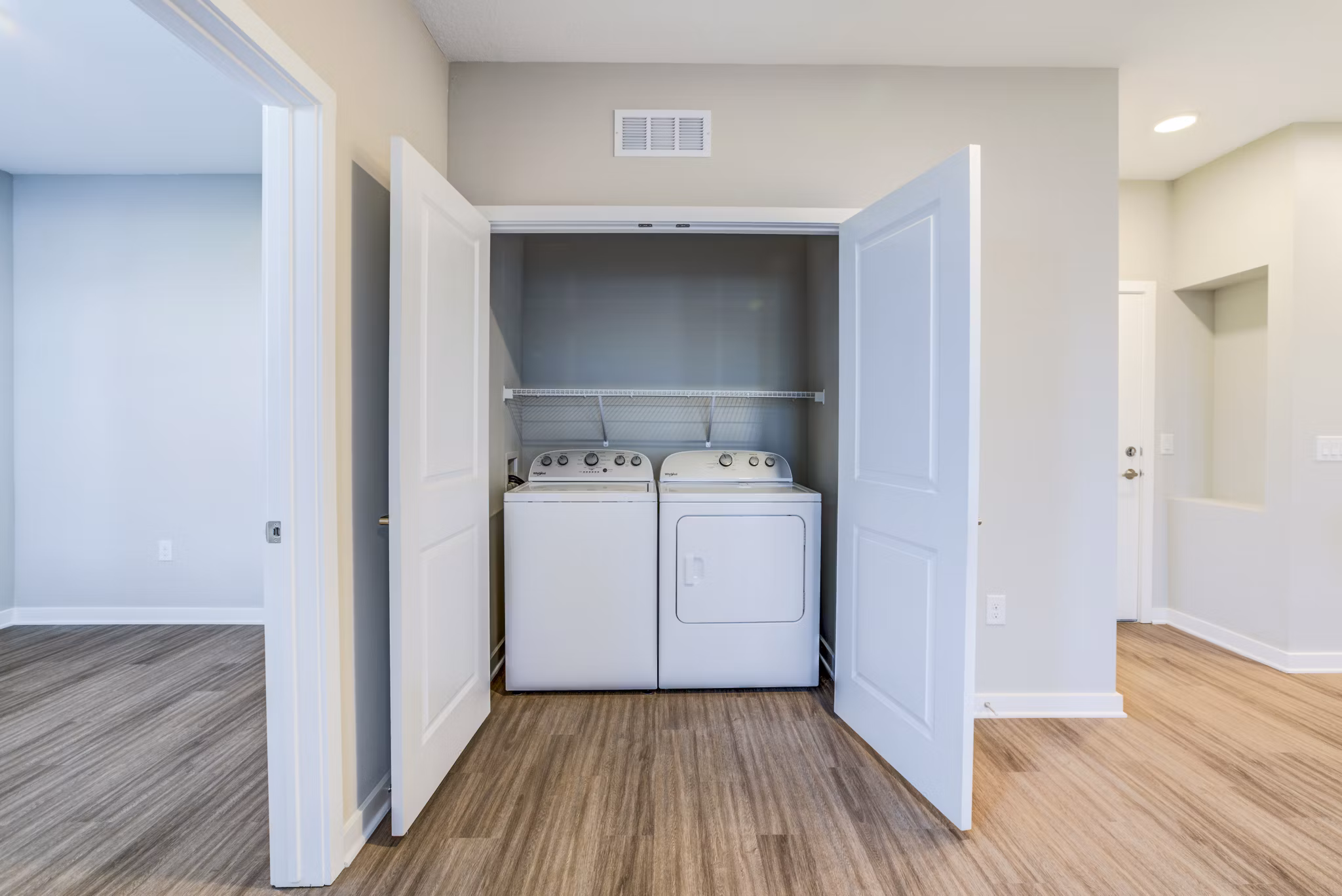 Laundry room with modern appliances at The Pointe at Siena Ridge Apartments