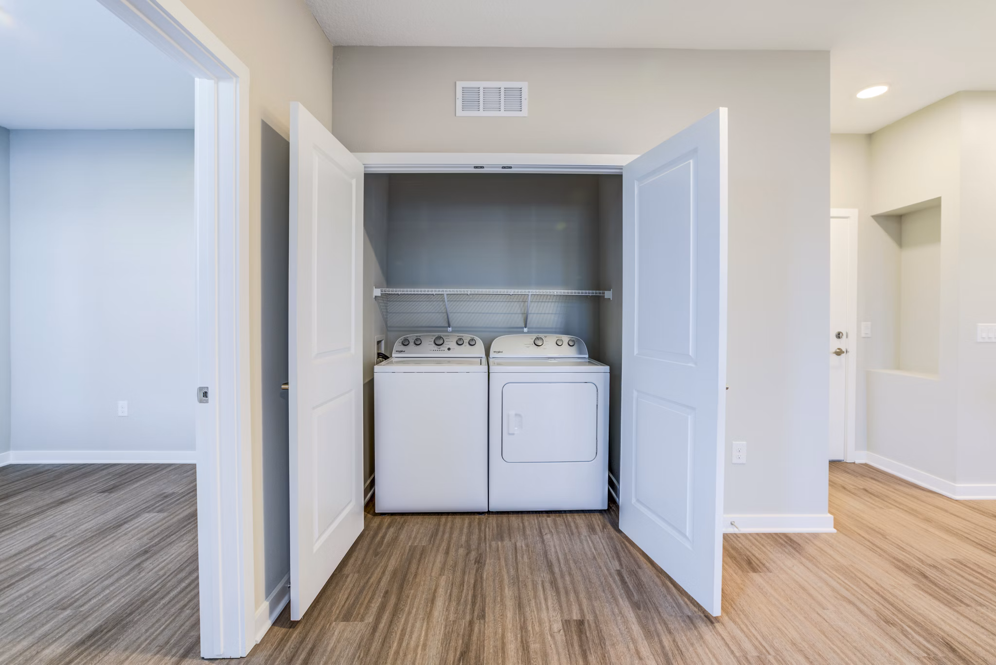 Laundry room with modern appliances at The Pointe at Siena Ridge Apartments