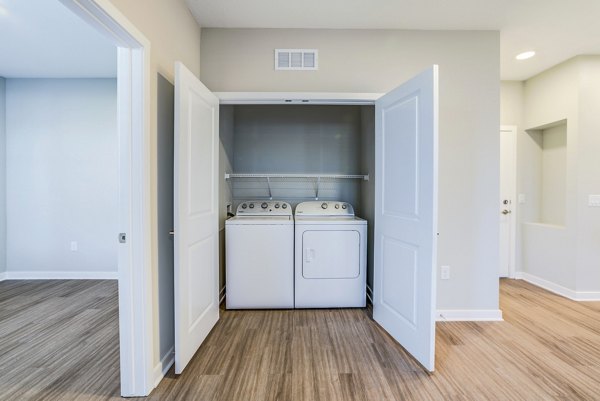 Laundry room with modern appliances at The Pointe at Siena Ridge Apartments