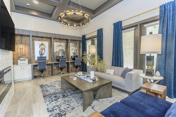 Clubhouse at Reserve at Lake Jackson Apartments: Elegant social space with modern amenities and comfortable seating in a vibrant community setting