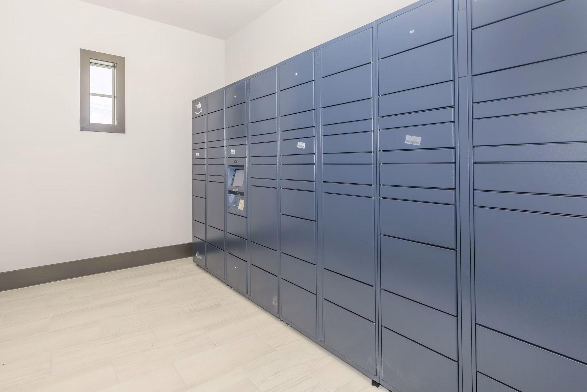 Modern mail room with organized lockers at Reserve at Lake Jackson Apartments