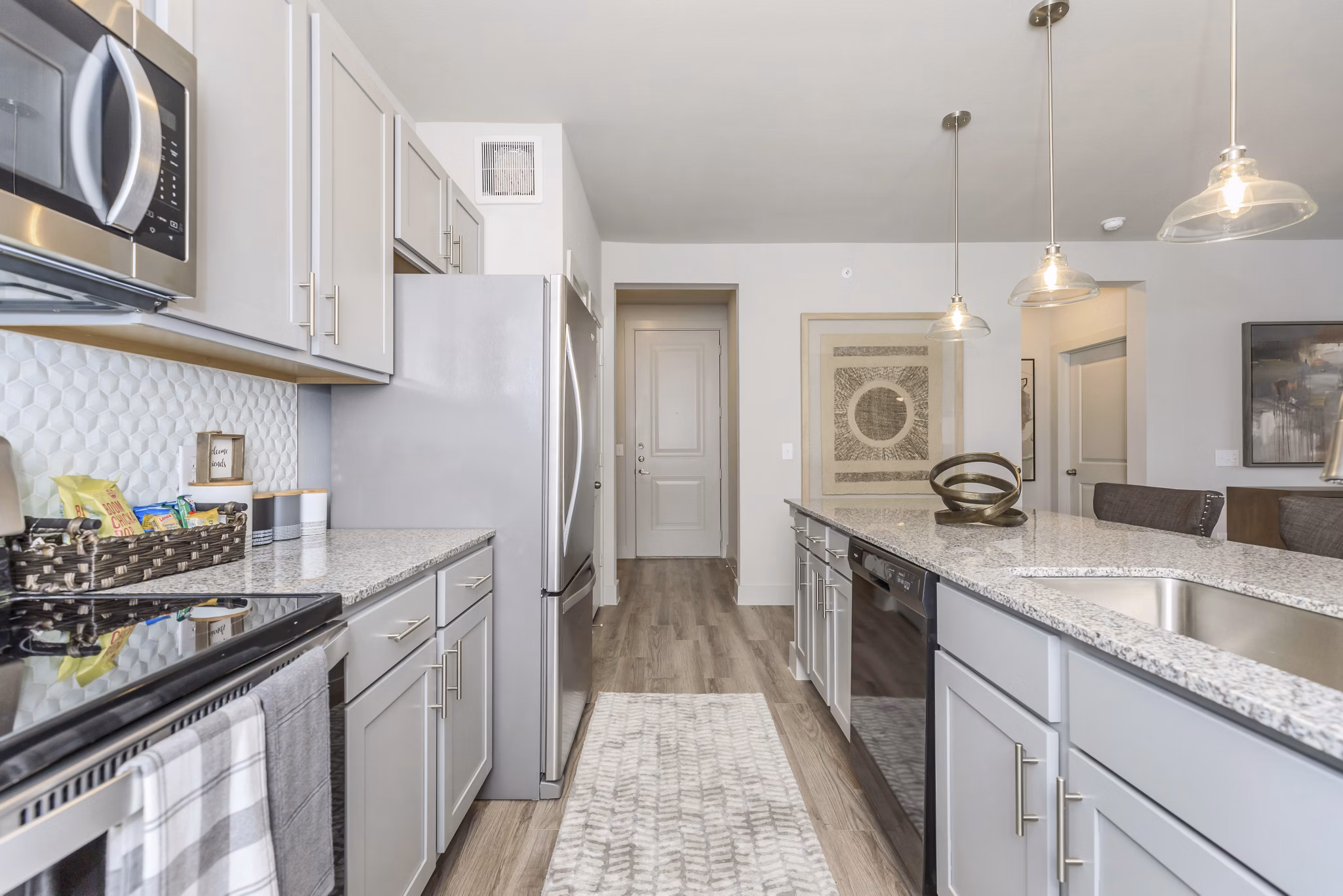 Modern kitchen featuring stainless steel appliances in Reserve at Lake Jackson Apartments