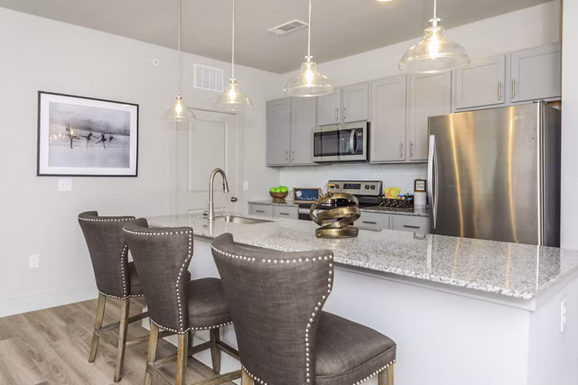 Kitchen featuring stainless steel appliances and granite countertops in Reserve at Lake Jackson Apartments