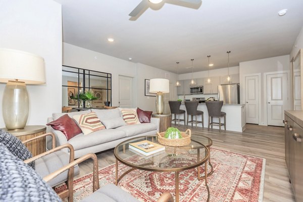 Living room featuring modern decor and large windows at Reserve at Lake Jackson Apartments