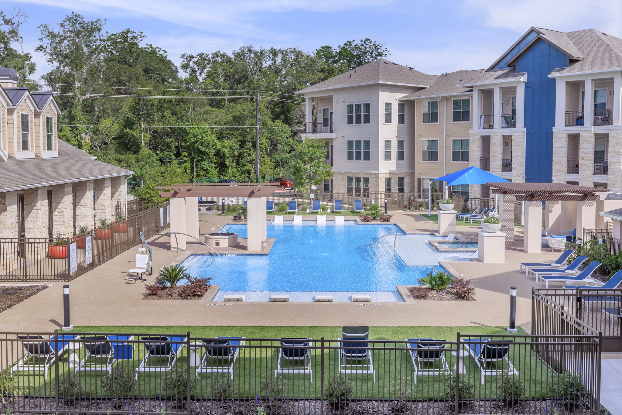Serene pool at Reserve at Lake Jackson Apartments with lush surroundings and lounge chairs