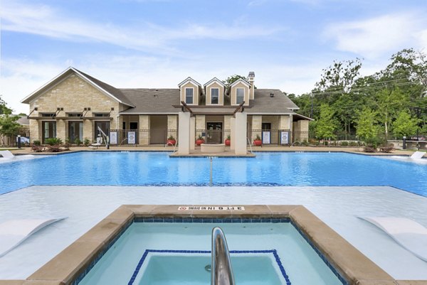 Resort-style pool area with lounge seating at Reserve at Lake Jackson Apartments