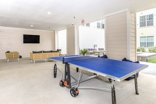 Patio area with comfortable seating and lush landscaping at Reserve at Lake Jackson Apartments