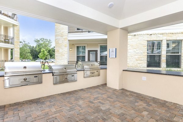 Outdoor grill area with modern seating at Reserve at Lake Jackson Apartments
