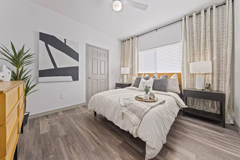 Cozy bedroom with modern decor in Cardinal 95 Apartments, offering luxury living spaces with stylish design elements